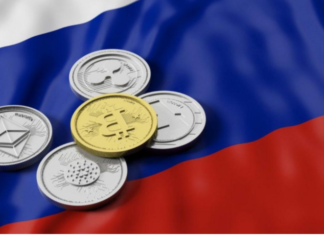 Russie : une banque fait le premier prêt en cryptomonnaie du pays Des pieces de monnaie sur un drapeau russe